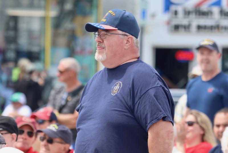 Navy veteran Terry Wieczorek stands for his service song, “Anchors Aweigh.” He said he spent 20 years in the Navy as a radioman, and he attends the Rehoboth event every year to pay tribute to all veterans.
