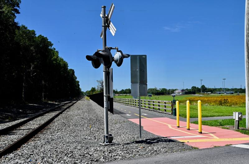 Some of the new sections of trail will run parallel to an active rail line and include a trail adjacent to the tracks protected by a fence like this section behind Sussex Academy in Georgetown.