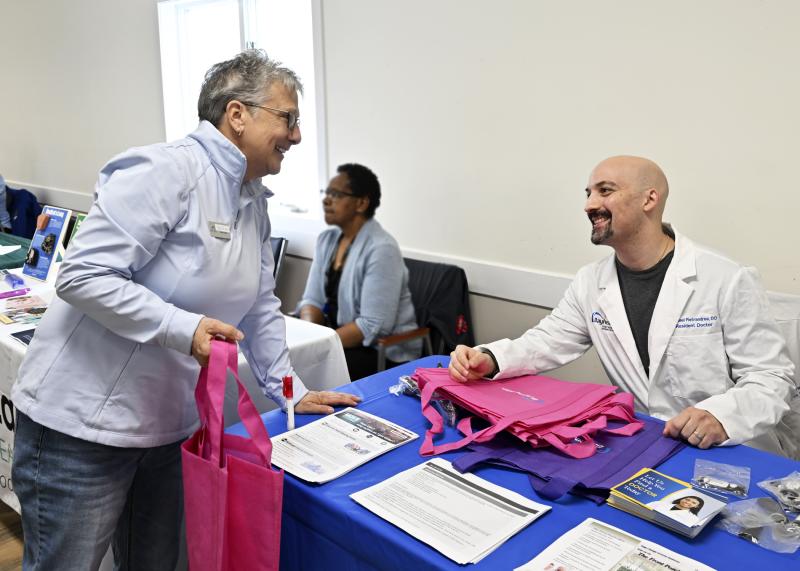 Sue Elliott, board member of the Lewes Senior Activity Center, and Dr. Michael Pietrandrea, a resident of Bayhealth Healthcare, are engaged in conversation.