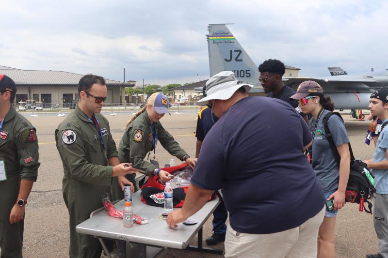 F-15E Strike Eagle pilots from North Carolina sell patches in front of the two airplanes they brought from Seymour Johnson AFB.