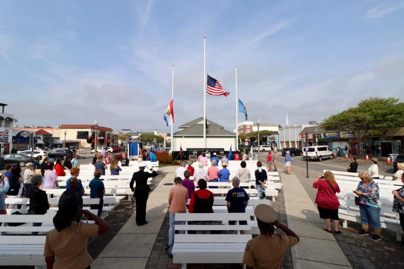 Many members of the crowd salute in honor of women service members, first responders and military service dogs who gave their lives for their country.