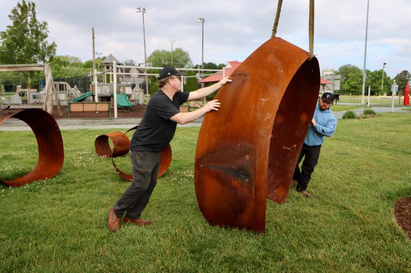 DeWitt Godfrey helps guide one of the larger pieces of the sculpture. He called the installation a success.