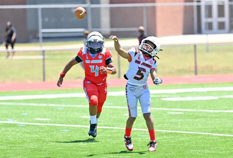 Team Silver quarterback Cayden White gets a pass off despite the chase by Team Red’s Trent “TJ” Lewis in the fourth- and fifth-grade showcase game.