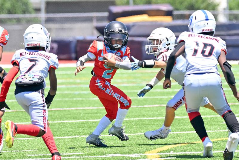 Team Red’s Bryce Cooper looks to hit the hole for a long gain in the fourth- and fifth-grade showcase game.