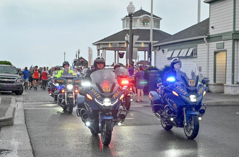The Delaware State Police Motorcycle Police Unit leads the Torch Run from the Rehoboth Beach Bandstand.