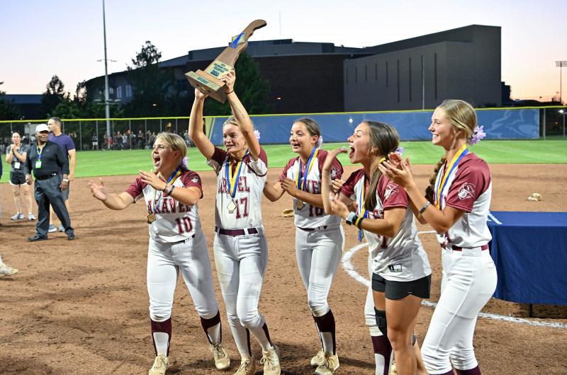 The Caravel seniors hoist the DIAA trophy. Shown are (l-r) Bethany Watkins, Kasey Xenidis, Katrina Baran, Kendall Browne and Paige Richardson.