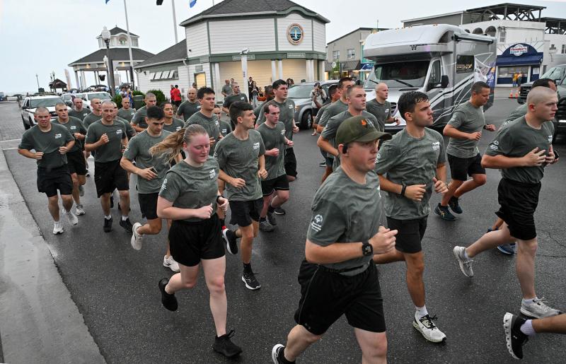 Members of the Delaware State Police and the Municipal Recruit Class depart from the Rehoboth Beach Bandstand.