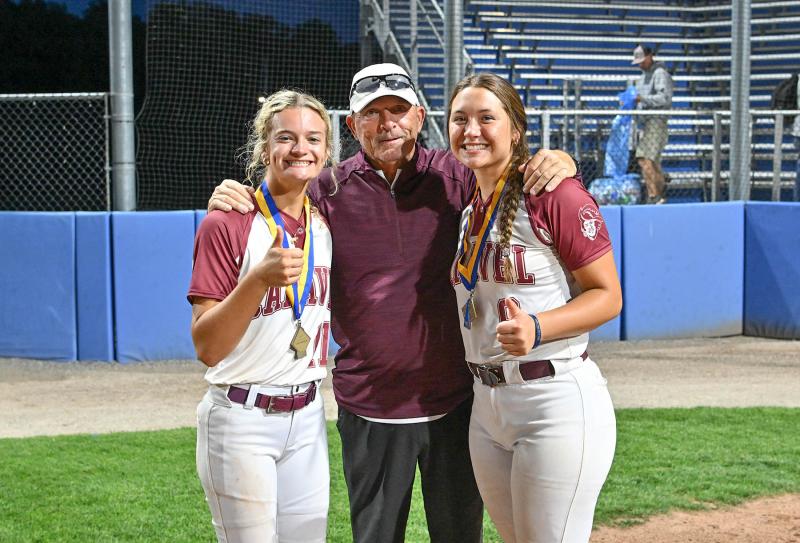 Cape alum and Caravel head coach Randy Johnson has a big DIAA State Championship smile with his battery of pitcher Kasey Xenidis, left, and catcher Zayda Rocke.