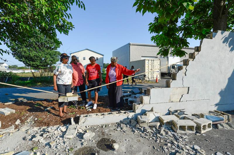 Shown looking over the damage are (l-r) West Side New Beginnings co-founder Brenda Milbourne, West Side New Beginnings co-founder Diaz Bonville, Dana Paskins and Waynne Paskins. DAN COOK PHOTO