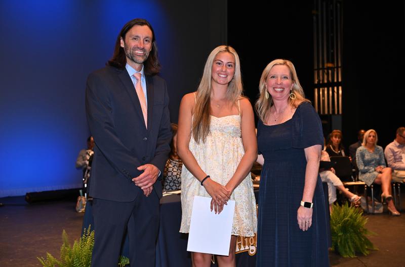 Olivia Burkentine is presented with the Senior Awards Program Cover Art Contest Award and the West Chester Academic Excellence Scholarship. Presenting the awards are Cape Assistant Principal Joshua Chubb and Principal Kristin DeGregory.