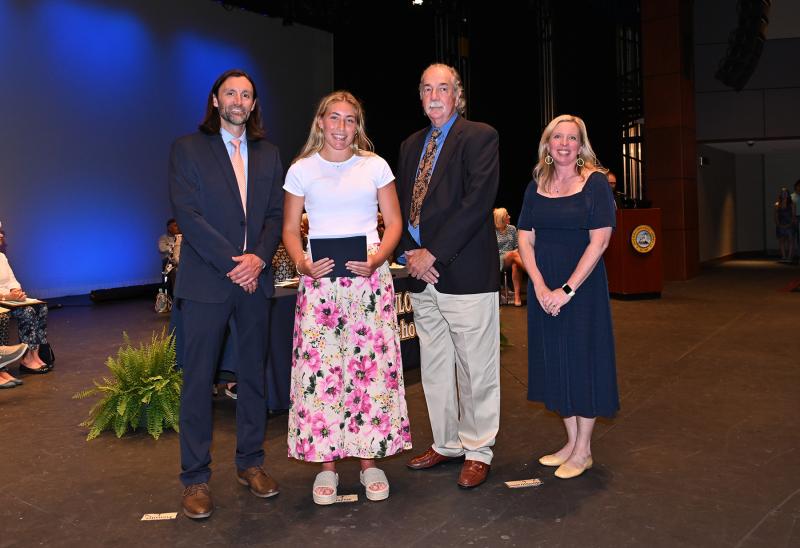 Carrie Clausius received the Bill Windett Memorial Scholarship, the Lou Norbeck Student-Athlete Scholarship, University of Tampa President's Merit Scholarship and UT Woman's Lacrosse Scholarship. Shown are (l-r) Cape Assistant Principal Joshua Chubb, Clausius, Lou Norbeck and Cape Principal Kristin DeGregory.