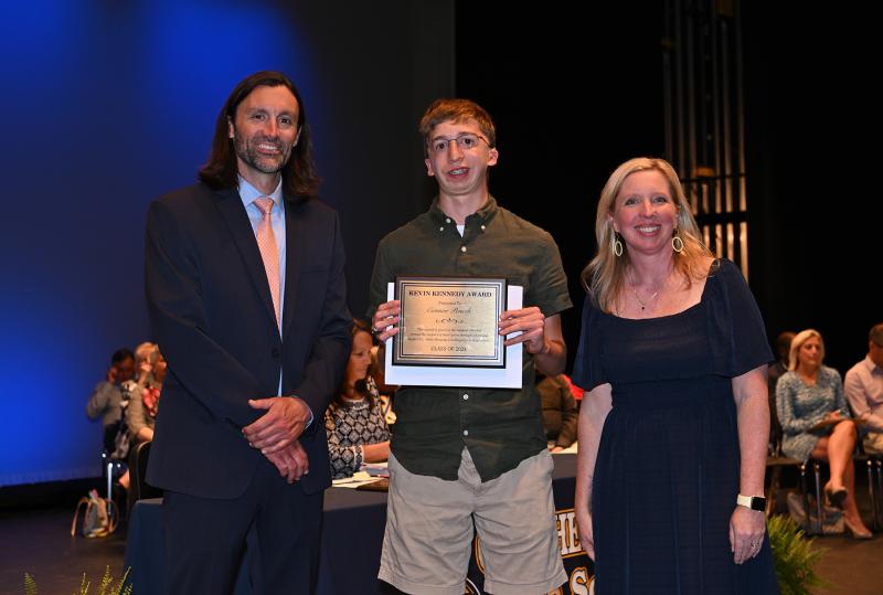Cape Assistant Principal Joshua Chubb, left, and Principal Kristin DeGregory present Connor Pencek with the Kevin Kennedy Award, which is voted on by the Cape coaches.