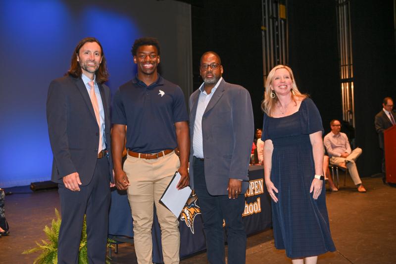 Maurki James receives an Old Dominion Football Scholarship and the Tammy Hopkins Scholarship Award. Shown are (l-r) Assistant Principal Joshua Chubb, James, Vaughn Hopkins and Cape Principal Kristin DeGregory.