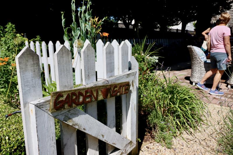A picket gate welcomes visitors to part of Amy Marasco’s expansive garden behind her Park Avenue house.