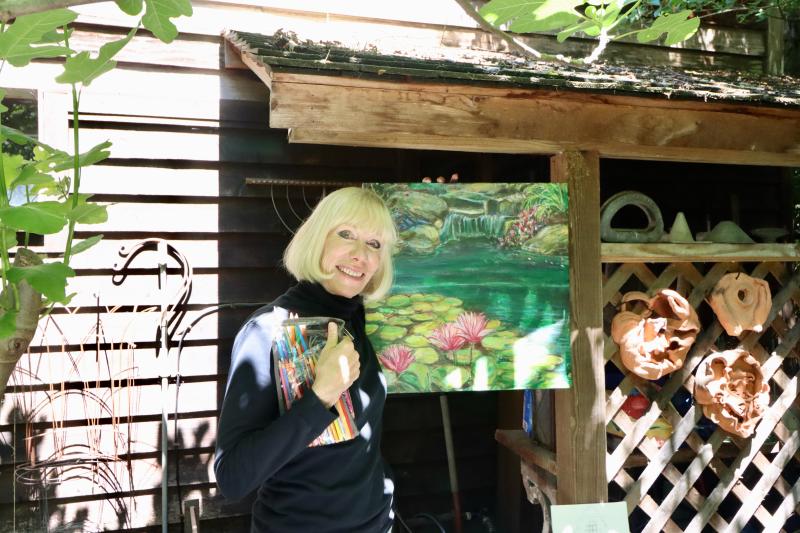 Patricia Truitt from the Cape Artist Gallery shows off her work at Steve and Lorraine Walker’s garden on Kings Highway. Truitt painted the garden during the tour.