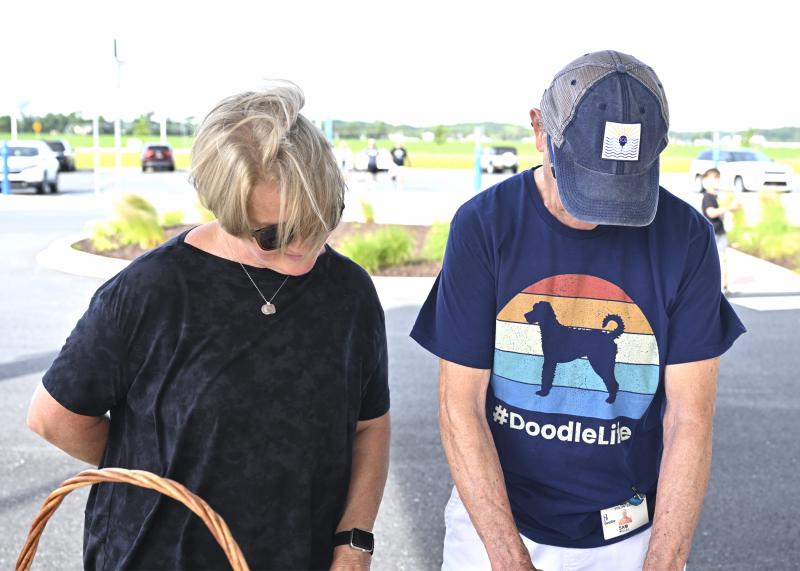 Kelley Barbieri of Hockessin, left, and Sam McClay, a two-time cancer survivor from Lewes, check in at the registration booth before the walk.