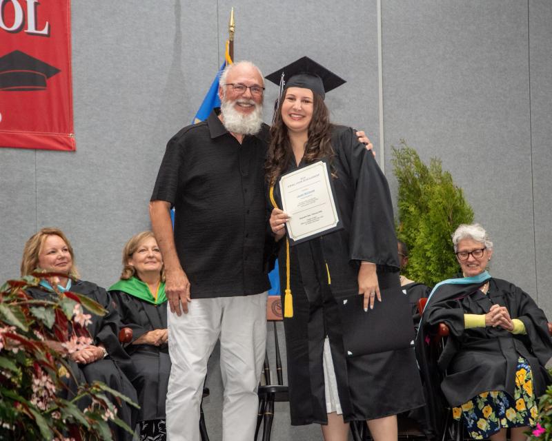 Former James H. Groves teacher Daniel Cook presents the Ethel M. Cook Memorial Scholarship for $1,000 to Lauren McConnell of Lewes. Ethel Cook graduated from the James H. Groves High School in 1989 at the age of 79. She always said, “You’re never too old to learn.” JAMES HILL PHOTO