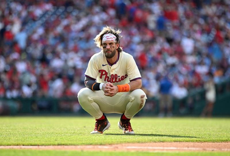 Phils star Bryce Harper takes a break in the heat July 13. Temps on the field reached over 100 degrees during the game.