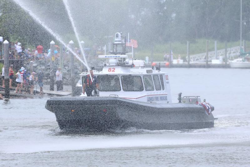 The Lewes Fire Department’s rescue boat leads the way for the annual July 4 boat parade down the canal.