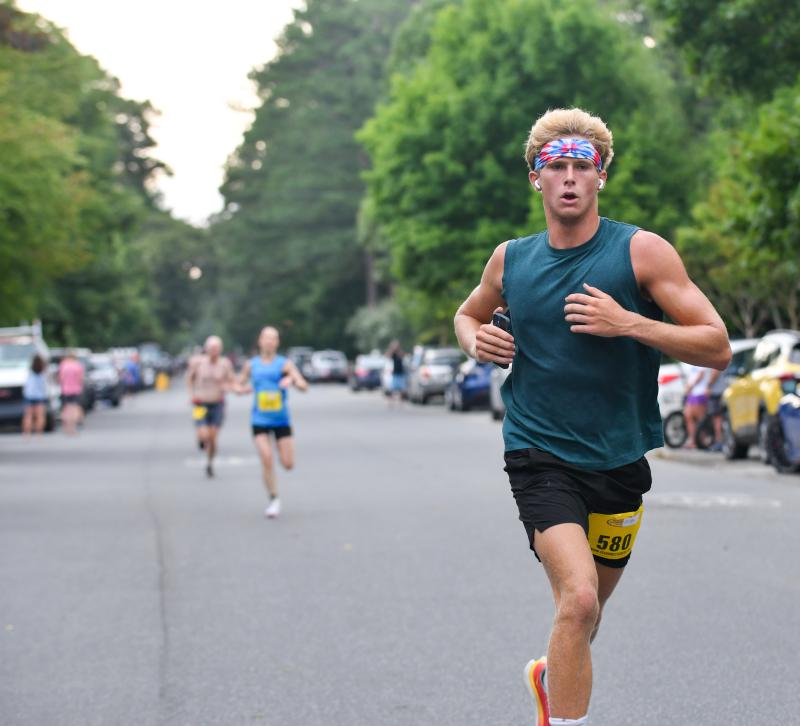 Liam Dennehy crosses the finish in 19:14.