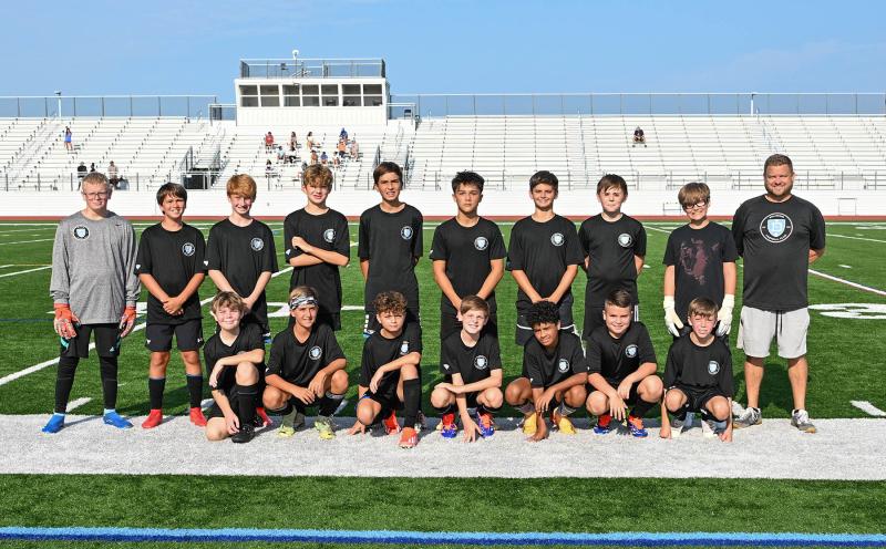 The DEFC South 2012 team gets together for a picture. They are in back (l-r) Cam Kilby, Finley Sherman, Callan McCartney, Braxton Handley, Lucca Tobias, Andrew Burke, Caden Chalmers, Austin Rowlands, Tommy Marshall and coach Patrick Kilby. In front are Josh Duko, Grant Sherman, Blake Jarecki, Ben Rodriguez, Carson Figueroa, Ethan March and Evan Steele.