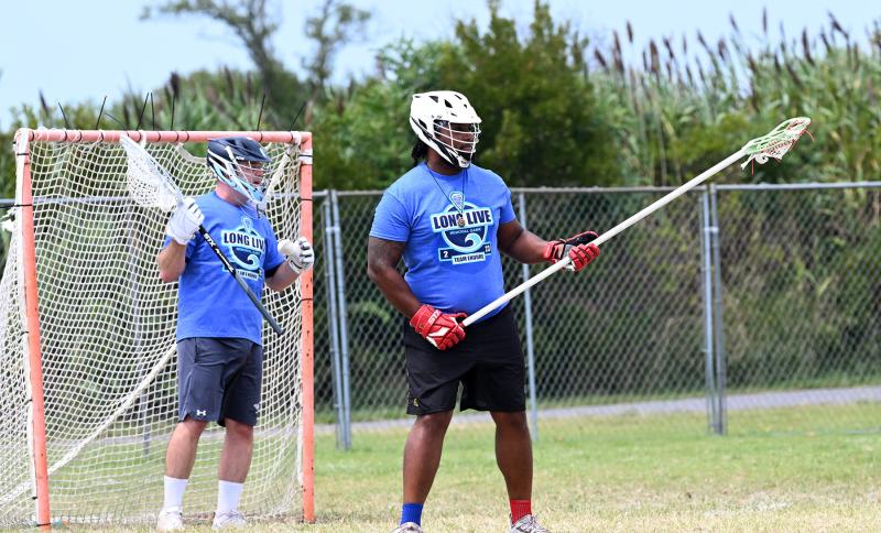 Cape volunteer coach Franc Cook, left, and Polytech grad Jovan Estrada hold down the defense for Team Endure Blue.