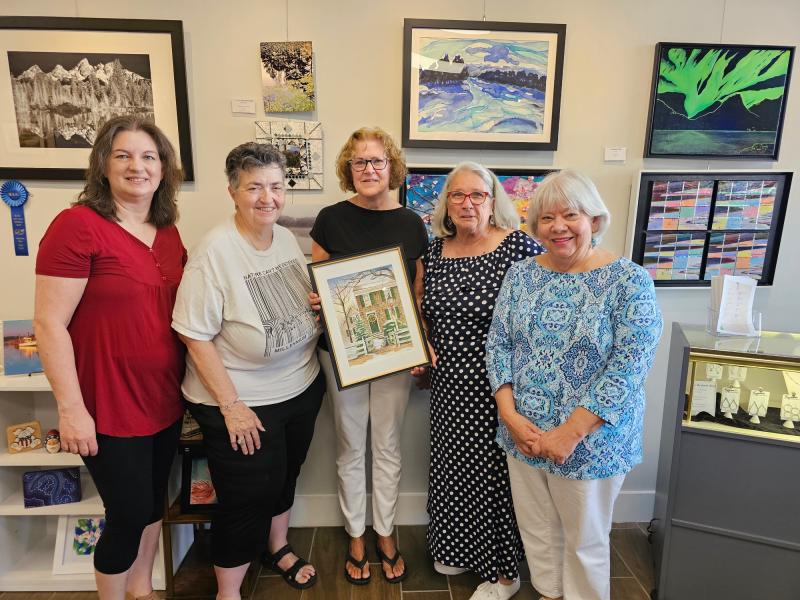 Watercolor artist Sue Marano shows her work selected for the Women's Club of Milton Holiday House Tour booklet cover. Shown are (l-r) Diane Bitterle, tour co-chair; Sue Dutton, Milton Arts Guild president; Marano; Betty Ann Dawson-Christ, club president; and Linda King, club fundraising committee chair. SUBMITTED PHOTO