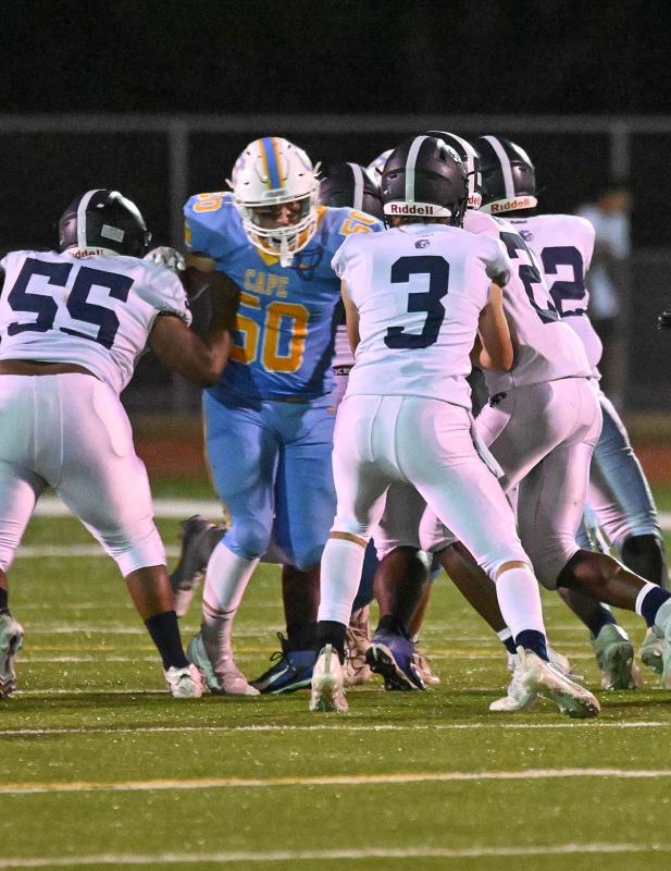 Cape junior linebacker Robbie Payton breaks through the offensive line to pressure Lake quarterback Jackson Parson. Payton made 12 tackles in the game.