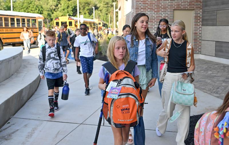 Ginny Keys carries her hockey stick for after-school practice at Fred Thomas Middle School. DAN COOK PHOTO
