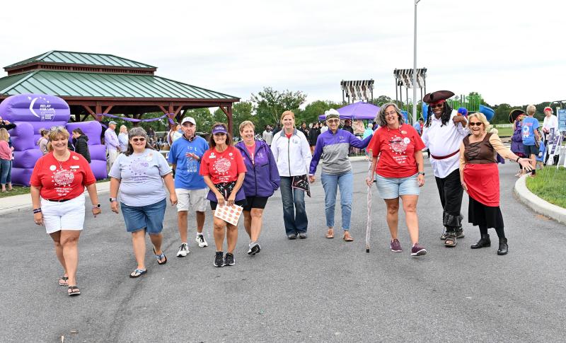 The Grand Club and All Star Club walk the circle during the Relay for Life event. Shown are (l-r), Kathy Blanchette, Heather Crouse, Rob Smith, Debbie White, Robin Ryan, Dareth Penuel, Bonnie McIlvain, Jeanne DiAmico, and Marlow and Julie Hicks. The Grand Club comprises people who have raised at least $1,000. The All Star Club recognizes those who have raised at least $2,500.