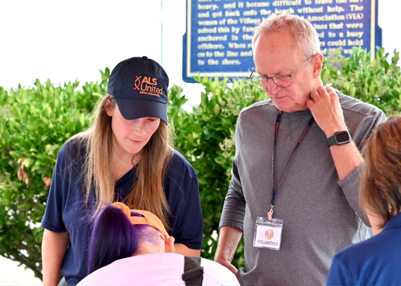 Taylor Montgomery, left, engagement manager for ALS United Mid-Atlantic, and volunteer Tom McGivney assist walkers with getting registered.