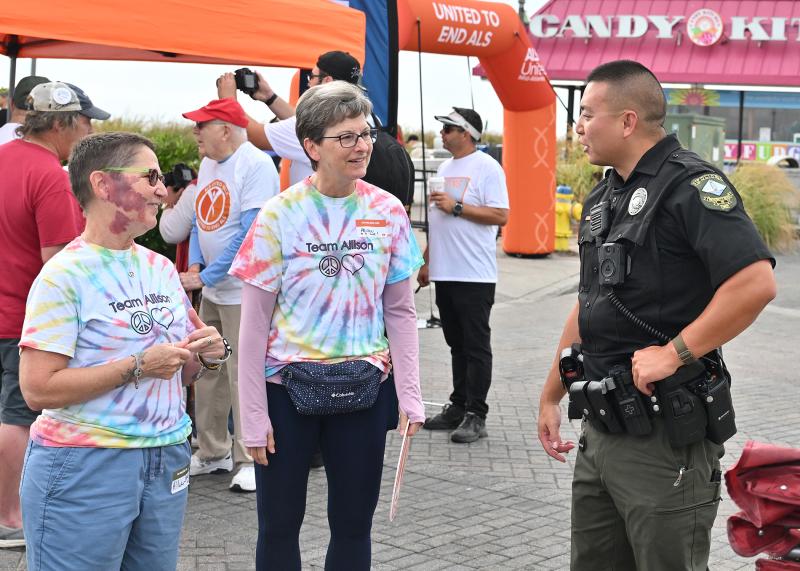 Carolyn Diefenderfer, left, and Lisa Fernandez talk with Patrolman Timothy Chan of the Rehoboth Beach Police Department.
