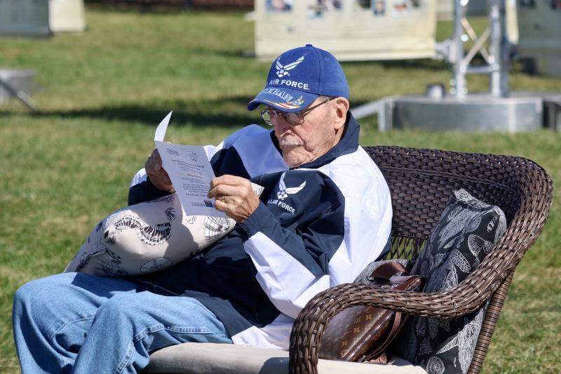 Air Force veteran Sam Patti, 92, reads the program for the opening ceremony for the Iraq/Afghanistan National Memorial at the Cape May-Lewes Ferry terminal Oct. 17. His grandson, Maj. Mark Anderson, was the pilot of the C-17 that did a fly-by during the ceremony.