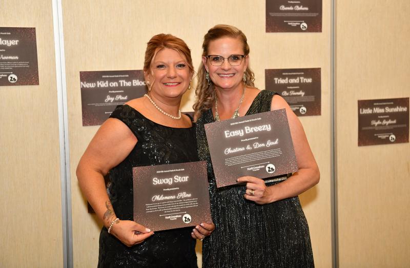 Philomena Kline, left, and Christina Gaul show off their appreciation certificates from the Grass Roots Rescue board.