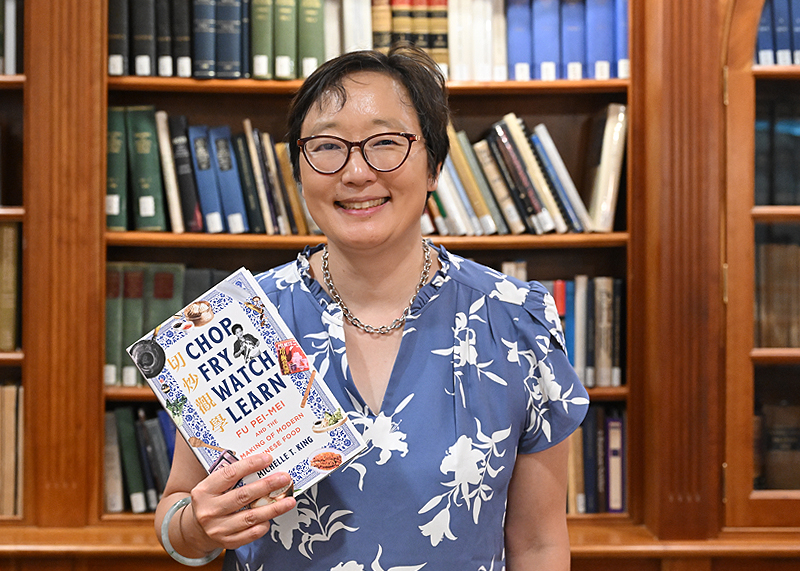 Michelle T. King holds her book, “Chop Fry Watch Learn: Fu Pei-Mei and the Making of Modern Chinese Food.” TED PFIRRMANN PHOTO