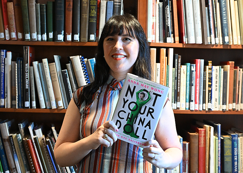 Katie Gee Salisbury holds her book, “Not Your China Doll, the Wild and Shimmering Life of Anna May Wong.” TED PFIRRMANN PHOTO