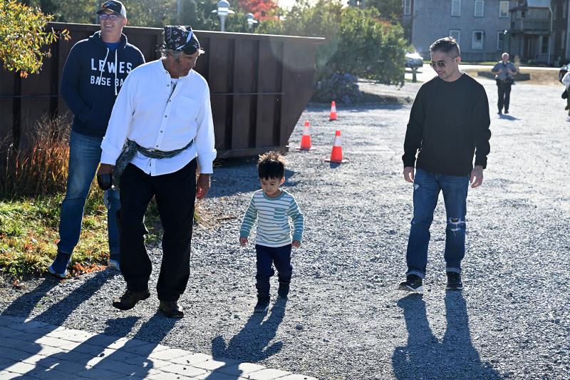 Leading 2-year-old Caden Flores to the Lightship Overfalls are (l-r) Sen. Russ Huxtable, D-Lewes; David Shook, president of the Overfalls Foundation; and Armando Flores.