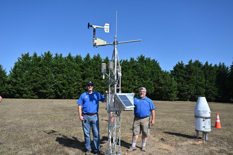 Kevin Brinson and Dave Huntley stand next to the weather station at the University of Delaware’s Environment Observing System.