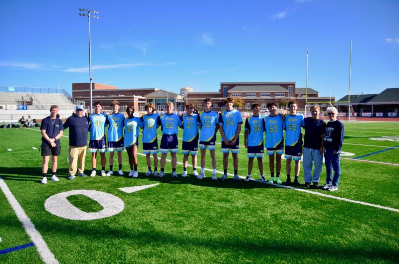 Cape unified flag football took time before the Morgan’s Message game against Indian River Oct. 29, to celebrate the 14 seniors in the Class of 2025. Shown are (l-r) coach Tony Palmer, coach Drew Messick, Brycen Stewart, Martin Silva, Laiya Ward, Ethan Willey, Harry Preston, Luke Pickard, Stephen Hart, Peter Koster, Dalen Daminger, Eddie Ghabour, Hank Anderson, Maxim Meadows and coach Theresa McCloy. Not shown are Randolph and Sophia Adams. AARON MUSHRUSH PHOTOS