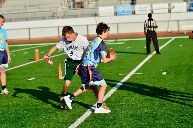 Cape freshman Xavier Zimmer tries getting upfield after catching a short pass, but IR senior Donald Lingo is there to pull his flag.