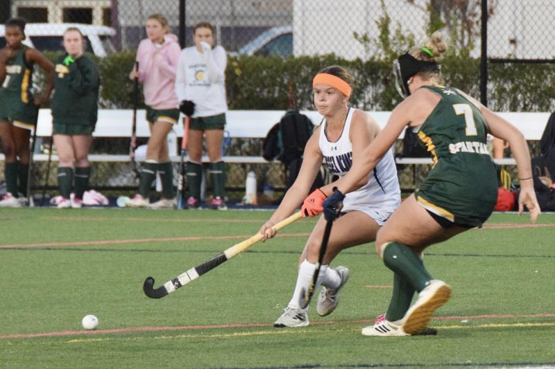 Seahawks senior Lente Werner passes the ball just outside the shooting circle. The orange, or oranje, fits Halloween but is for her homeland, the Netherlands. JAXON LAUX PHOTO