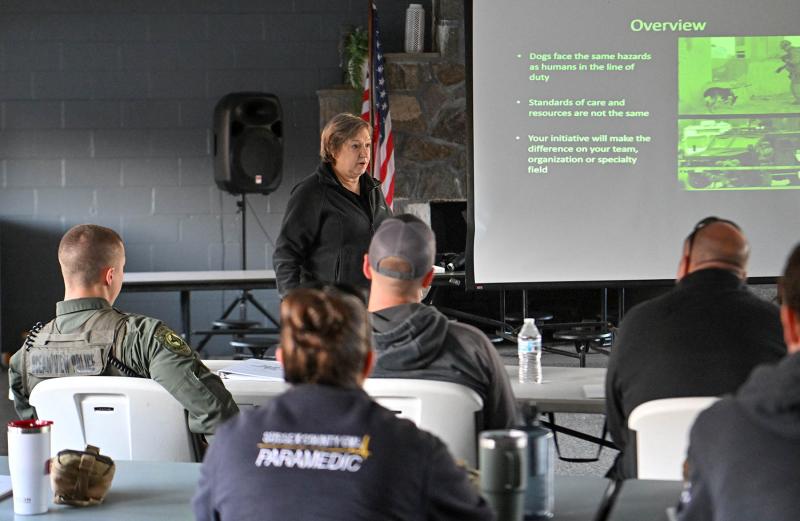 Janice Baker, DVM, DACVPM, MS, speaks to attendees about the importance of speed in taking care of a wounded K-9.