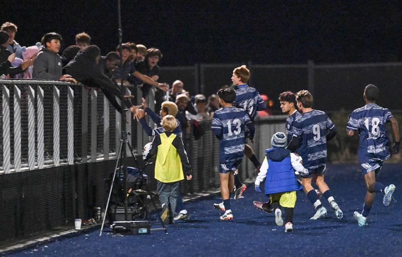 Andres Romero-Nieto and his teammates celebrate the winning shot with the Sussex Academy student section.