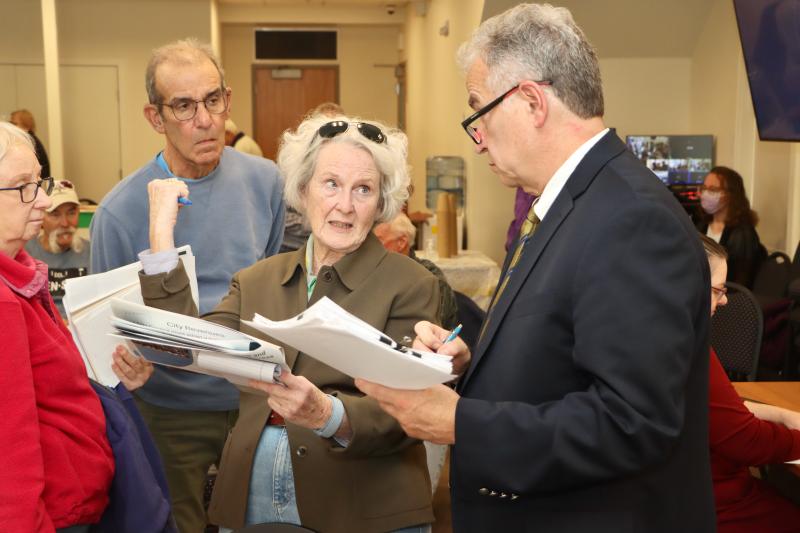 Elizabeth McCaffrey, left, talks to city engineer Charlie O’Donnell about infrastructure. O’Donnell said it would take about $30 million over 10 years to bring every street that is in need on maintenance up to a brand new standard.
