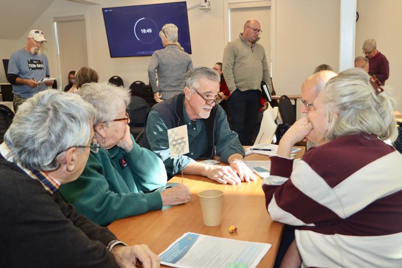 Councilman Joe Elder, center, a Lewes Financial Stewardship Subcommittee co-chair, talks to residents at the charitable donations table at the workshop. The city wants to know if it should continue to include donations to nonprofits in its budget.