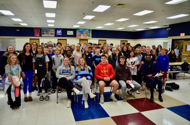 Four Cape athletes destined to continue their athletic careers in college spoke with a cafeteria full of Beacon Middle School students about what to expect during the recruiting process and the best ways for the kids to boost their recruiting profiles. Shown sitting are (l-r) Alivia Heers, Lina Frederick, Patrick Donahue, Ronan Presler and Assistant Principal Dontez Collins. AARON R. MUSHRUSH PHOTOS