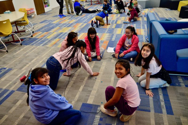 Enjoying a game of marbles are (clockwise from left) Valeria Sanchez-Salinas, Karla Ortiz Hernandez, Jaylen Calderon Martinez, Darlyn Carballo Medina, Ariadne Domingo-Santiago, Evellyn Avendo Castano and Ami Morales Mejia.