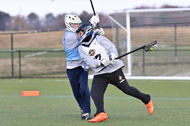 Stephen Decatur Maryland Boys middie John Fohner dodges around Ellendale Renegades player Eric Uffelman of Cape in the final.