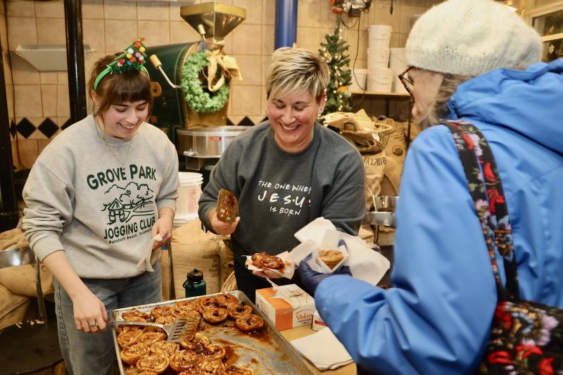 Ashlyn Warner and Tara Woods hand out fresh, hot sticky buns to customers at Lewes Bake Shoppe. They were among the downtown Lewes merchants who were saying thanks with treats on Hospitality Night.