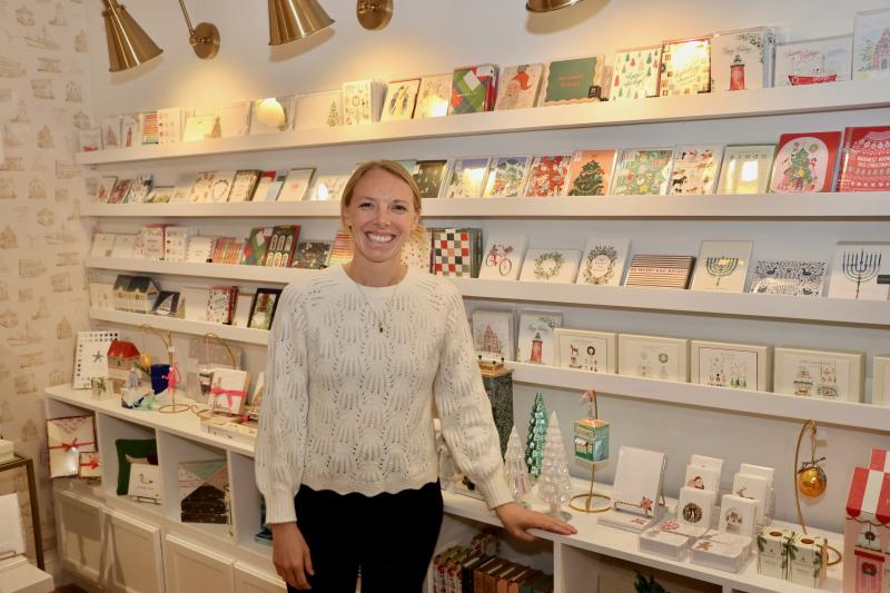 Katy Ackerman, owner of Lewes Lettering Co., stands in front of her custom Christmas cards. She was offering handwritten letters to Santa.